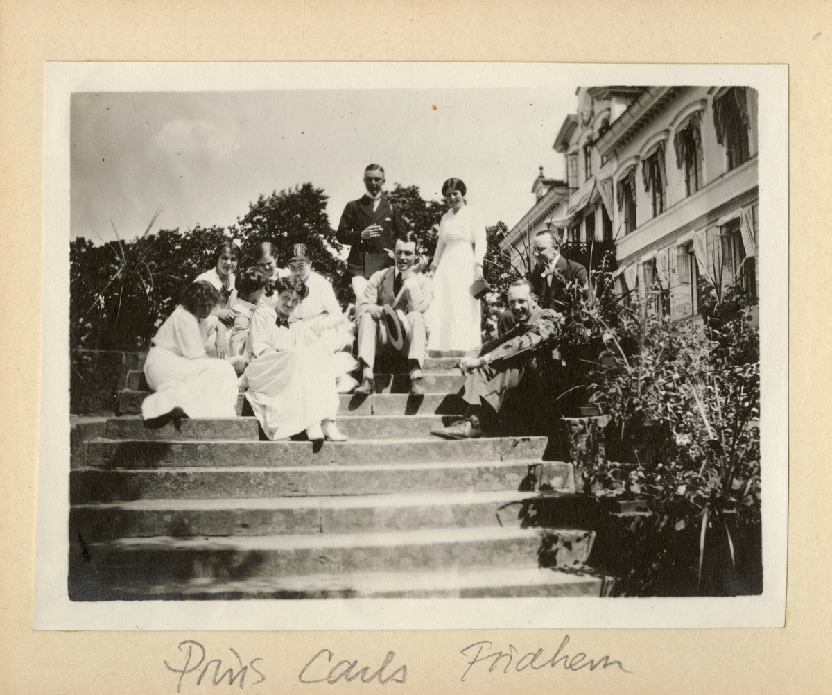 Män och kvinnor sitter i trapp, troligen vid prins Carls villa Parkudden på Djurgården i Stockholm.