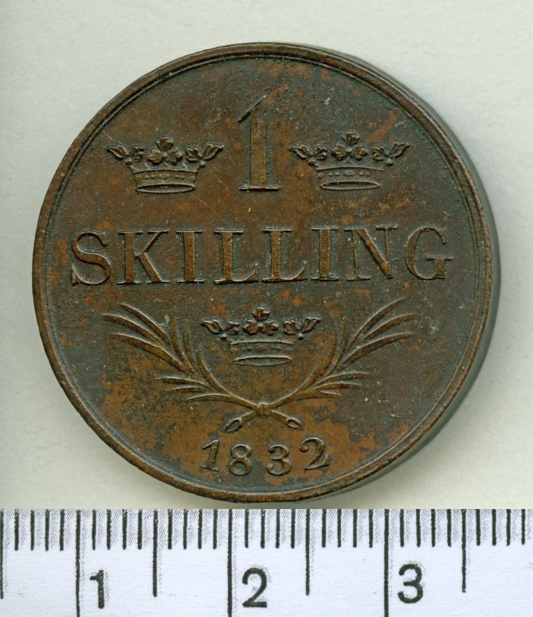 Mynt, sentida kopia av 1 skilling 1832, Carl XIV Johan.

Myntet är i 2 delar som visar fram och baksida.