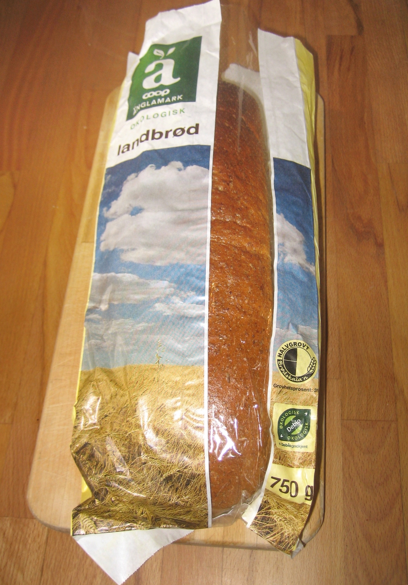 Motiv på posen er en åker med modent korn. Over åkeren ser man en blå himmel med hvite skyer