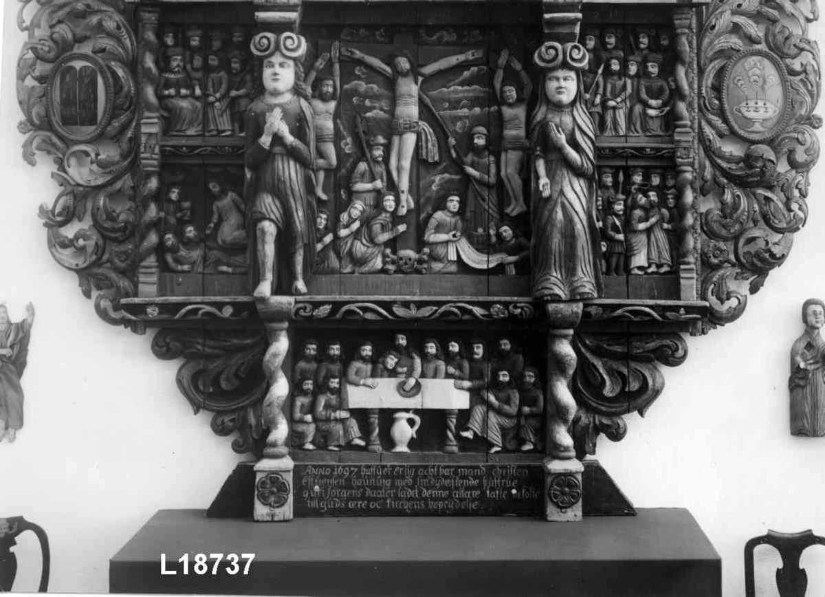 Nederste felt: Nattverden. Midtre felt: Korsfestelsen. Kristus som Salvator Munid (Verdens Frelser). Øverst: Oppstandelsen. Kristus med rød seiersfane. Scener fra pasjonshistorien i de små feltene. 